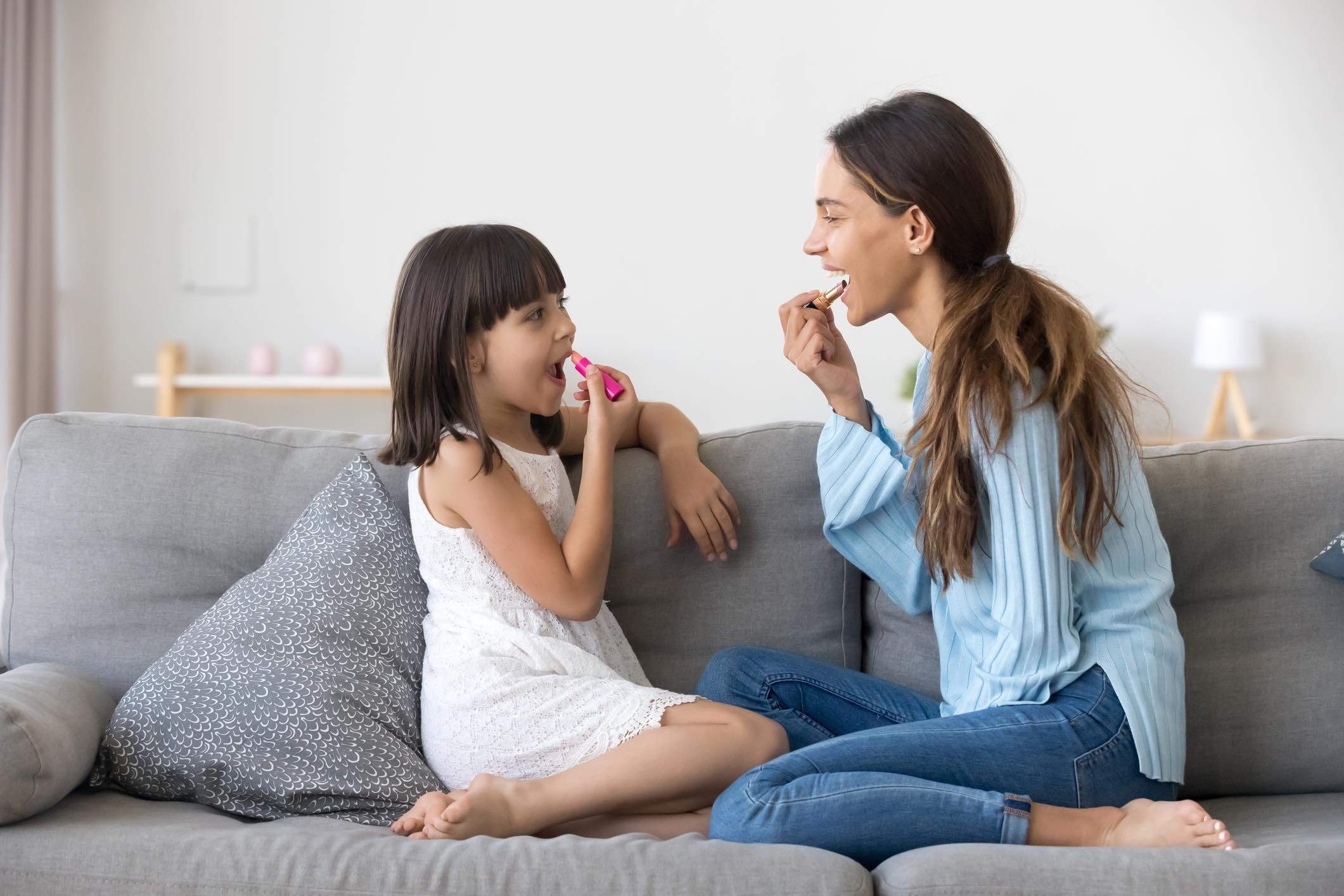 Имеет дочь. Mother and daughter are having a lot of fun and laughs while watching TV in the Living Room sitting on the Couch..